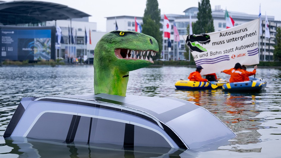 Mitglieder von Attac demonstrieren vor der Eröffnung der Internationalen Automobil-Ausstellung (IAA Mobility) mit einem „Autosaurus“ im Messesee für eine Mobilitätswende. Die IAA Mobility 2025 findet vom 09.-14.09.2025 in München statt.